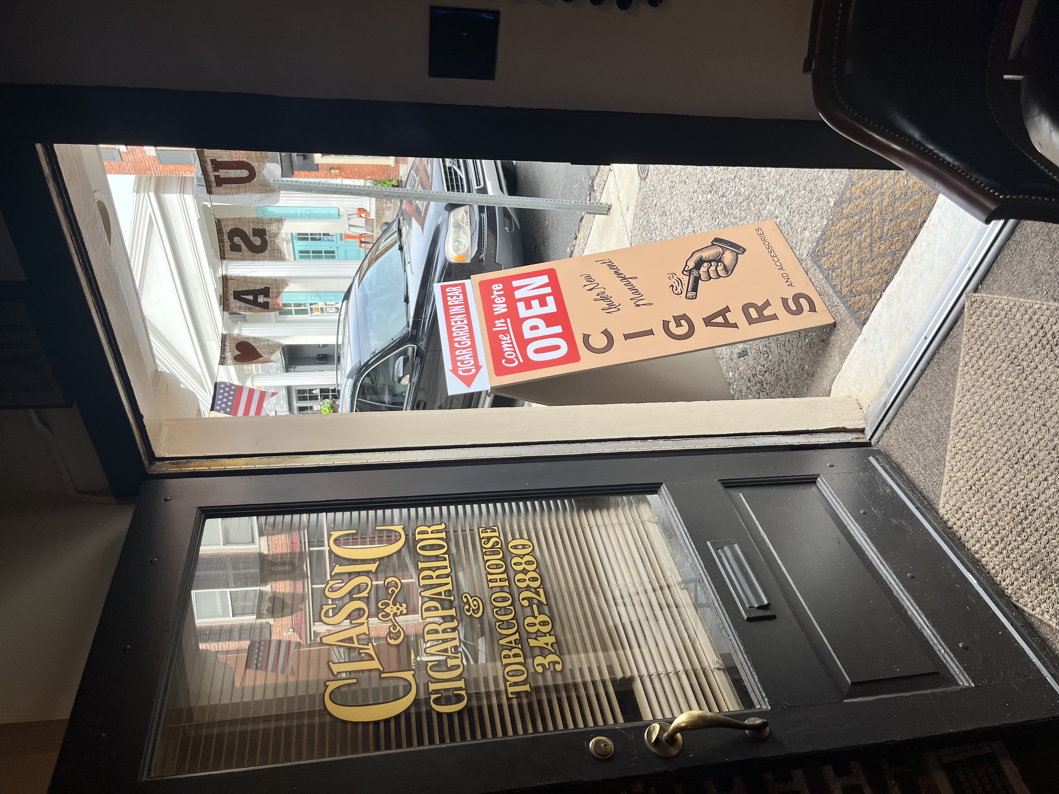 The view out of the front door onto North Main Street, with the gold Classic Cigar Parlor lettering on the glass